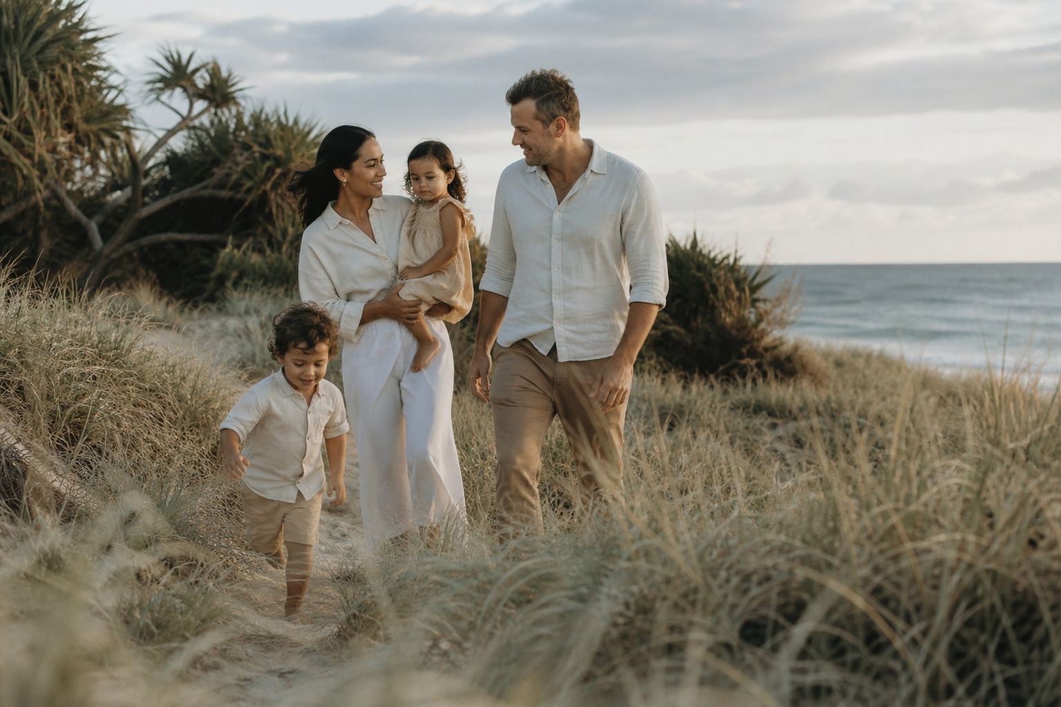 Family walking together through Sunshine Coast dune grass