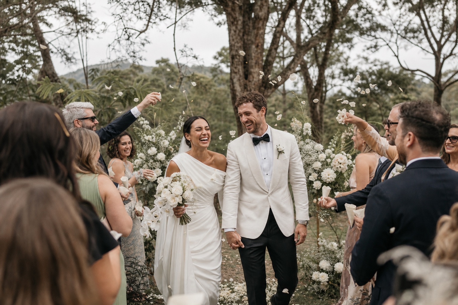 Guests celebrating around newlyweds after their garden ceremony