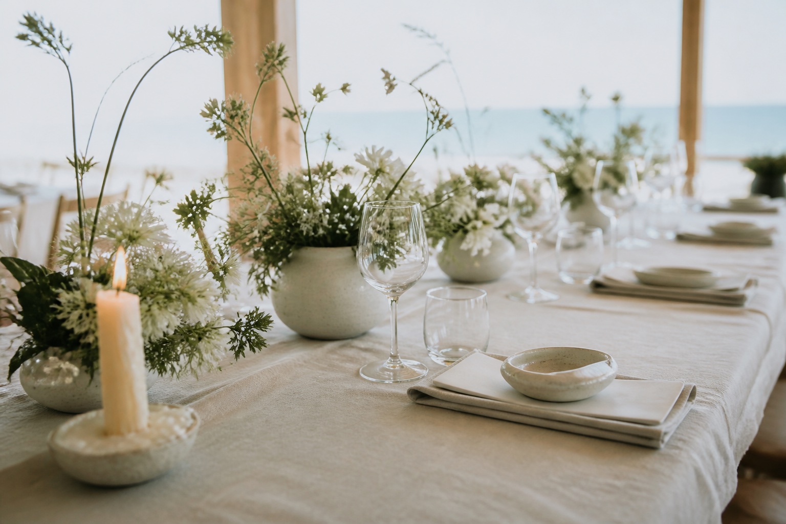 Coastal wedding table with linen and sculptural white flowers