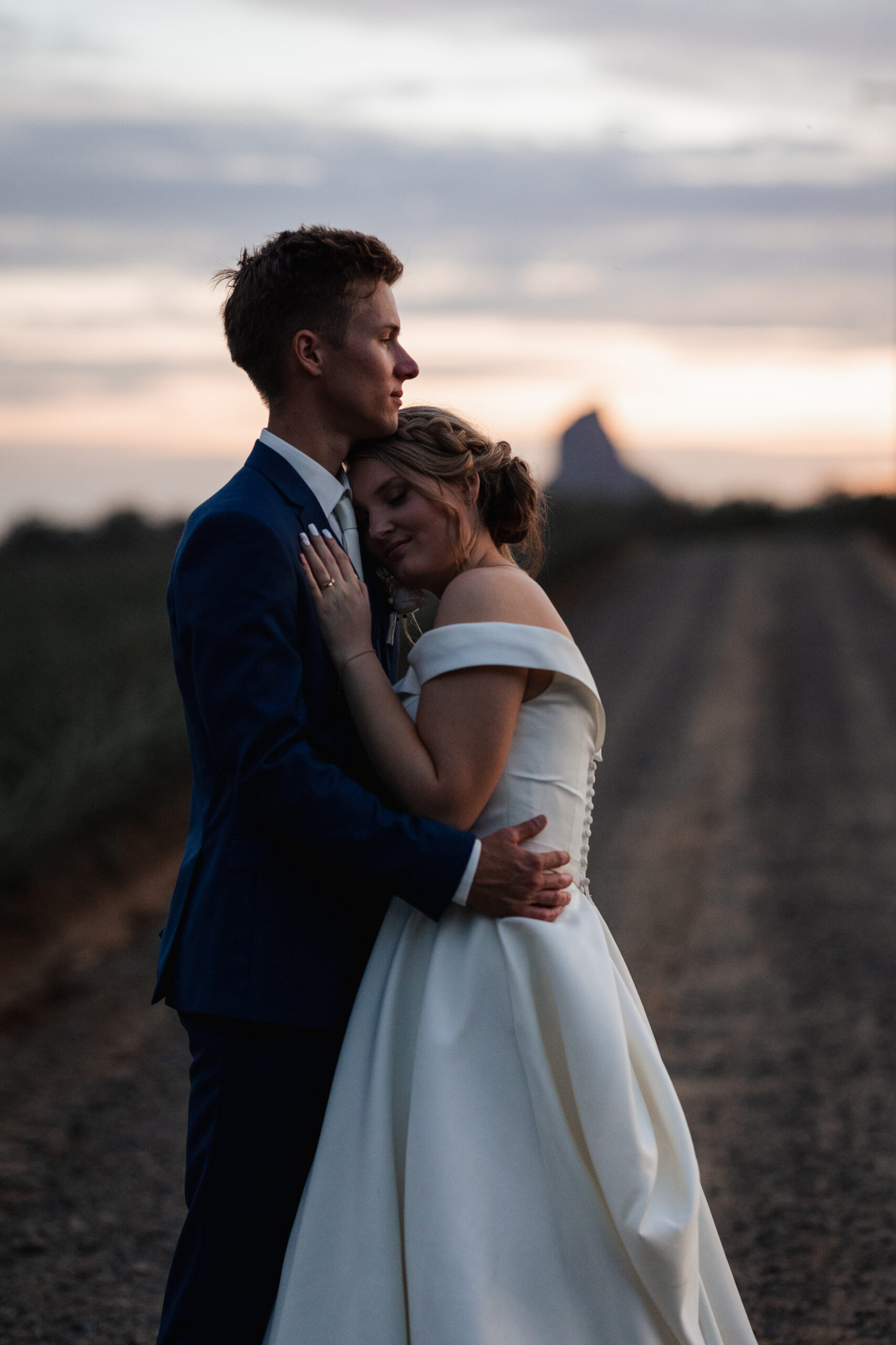 Newlyweds sharing a joyful first dance by candlelight