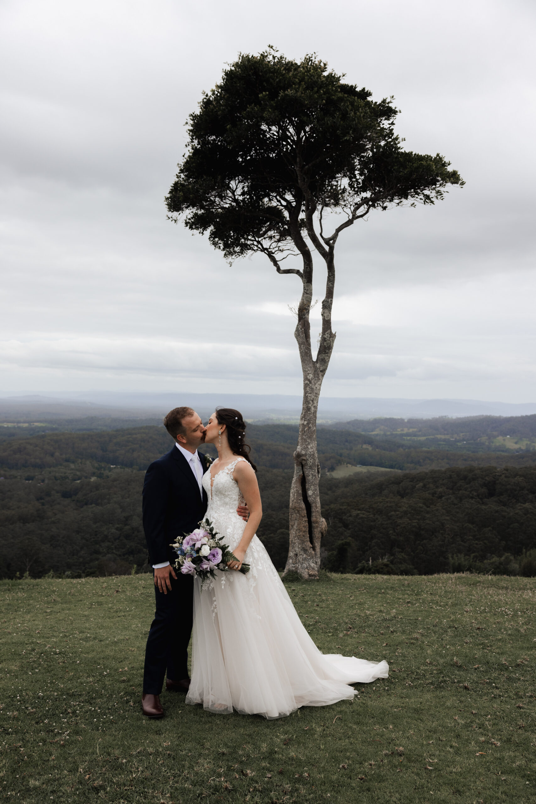 Newlyweds crossing a sunlit architectural terrace