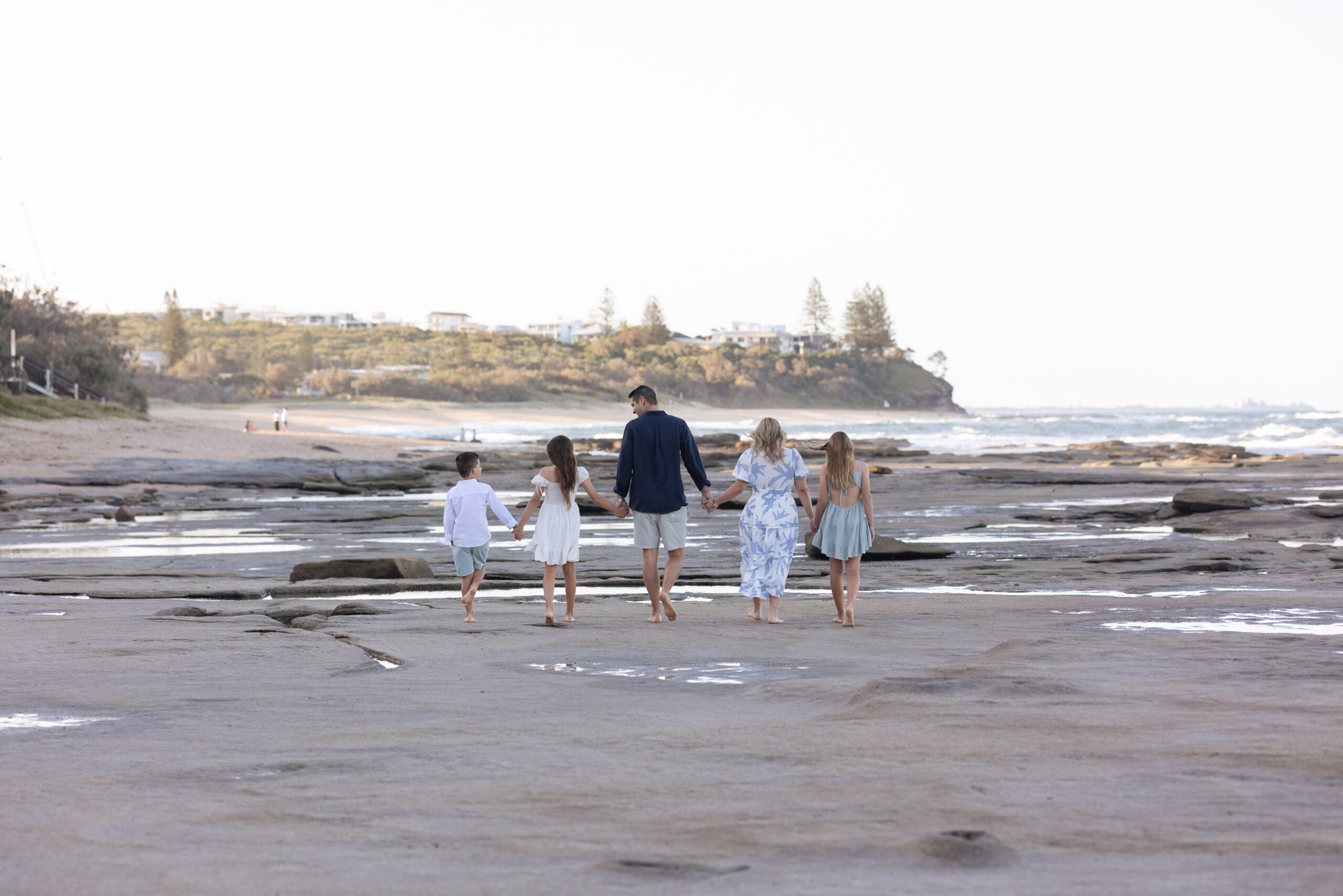 Family walking together through coastal dunes